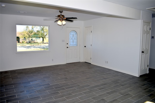 foyer entrance with ceiling fan and dark hardwood / wood-style flooring