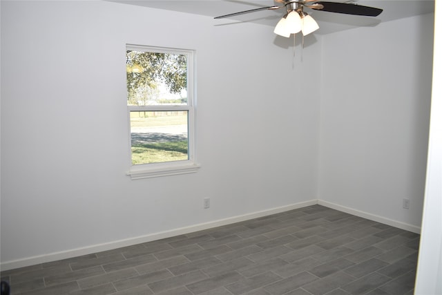 empty room featuring ceiling fan and dark hardwood / wood-style flooring