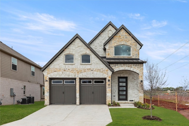 3100 Summer Rain Ln, Anna, TX 75409 - french country home featuring stone siding, driveway, a front lawn, and an attached garage
