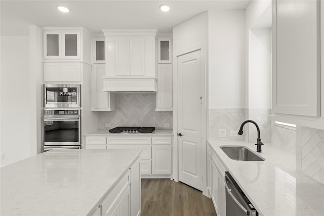 3100 Summer Rain Ln, Anna, TX 75409 - kitchen with stainless steel appliances, light stone counters, white cabinets, glass insert cabinets, and recessed lighting
