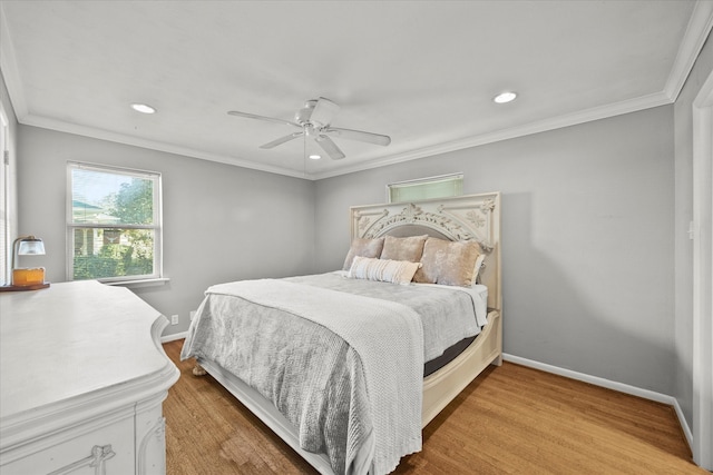 bedroom with hardwood / wood-style floors, ceiling fan, and crown molding