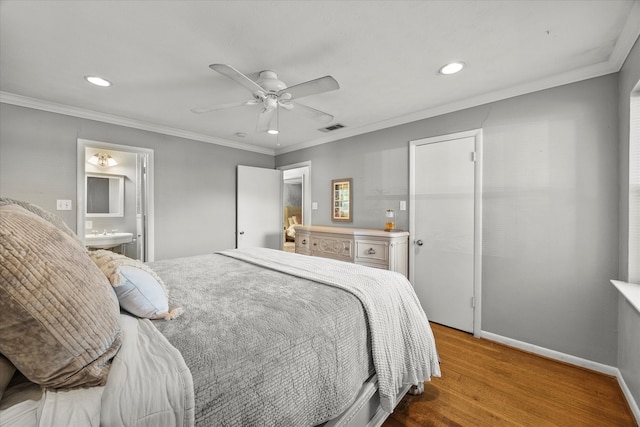 bedroom with connected bathroom, ceiling fan, hardwood / wood-style floors, and ornamental molding