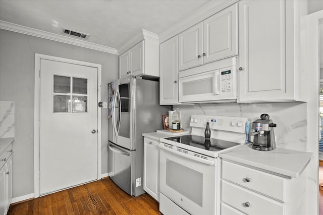 kitchen featuring white appliances, white cabinetry, dark wood-type flooring, and crown molding