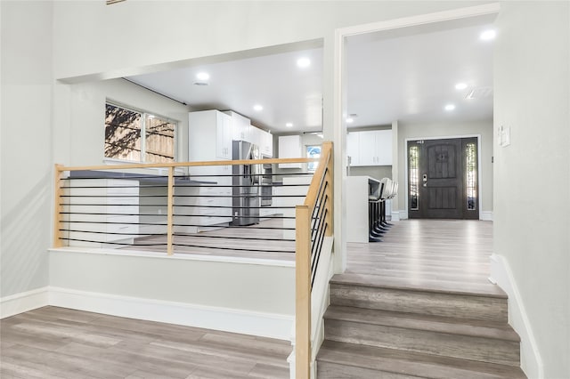 stairs with hardwood / wood-style flooring