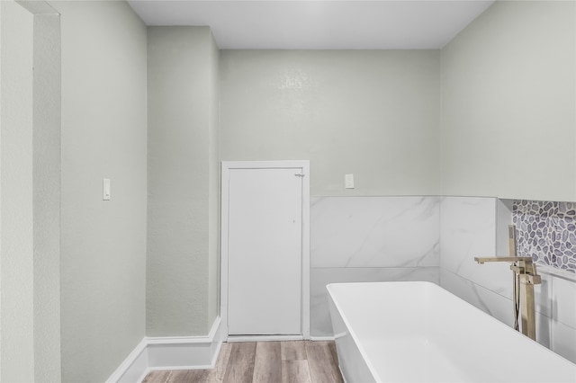 bathroom featuring hardwood / wood-style flooring and a bathtub