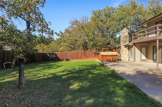 view of yard with a patio and a hot tub