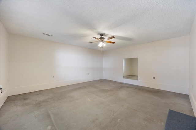 spare room with ceiling fan, concrete flooring, and a textured ceiling