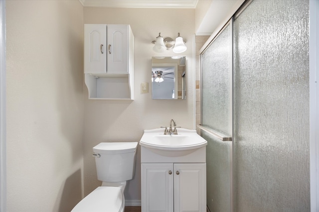 bathroom with vanity, ceiling fan, toilet, ornamental molding, and walk in shower