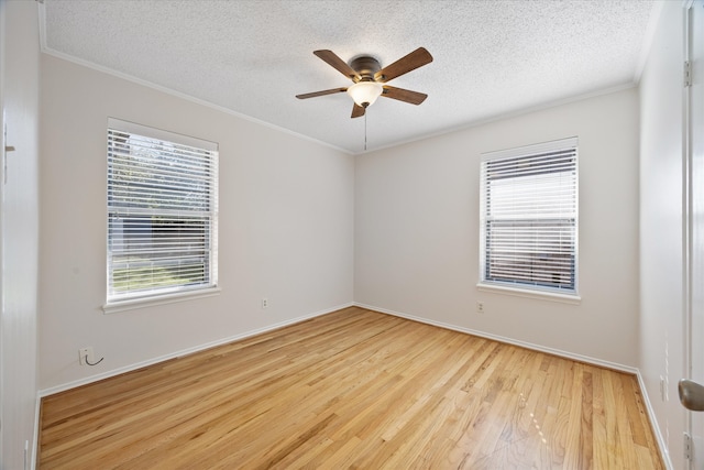 empty room with crown molding, light hardwood / wood-style flooring, ceiling fan, and a textured ceiling