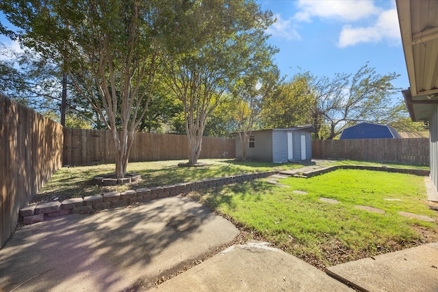 view of yard featuring a patio area and an outbuilding