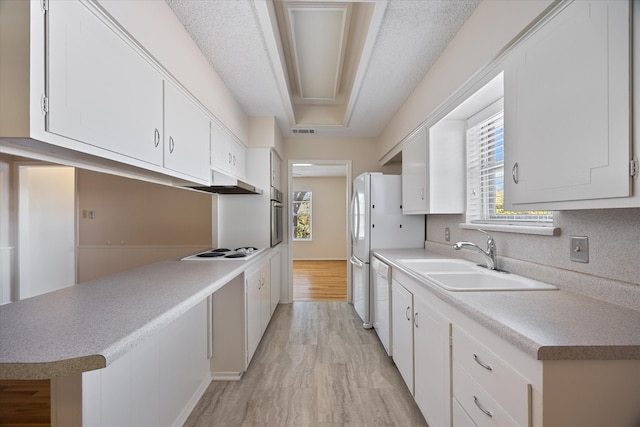 kitchen with white cabinetry, a healthy amount of sunlight, and sink