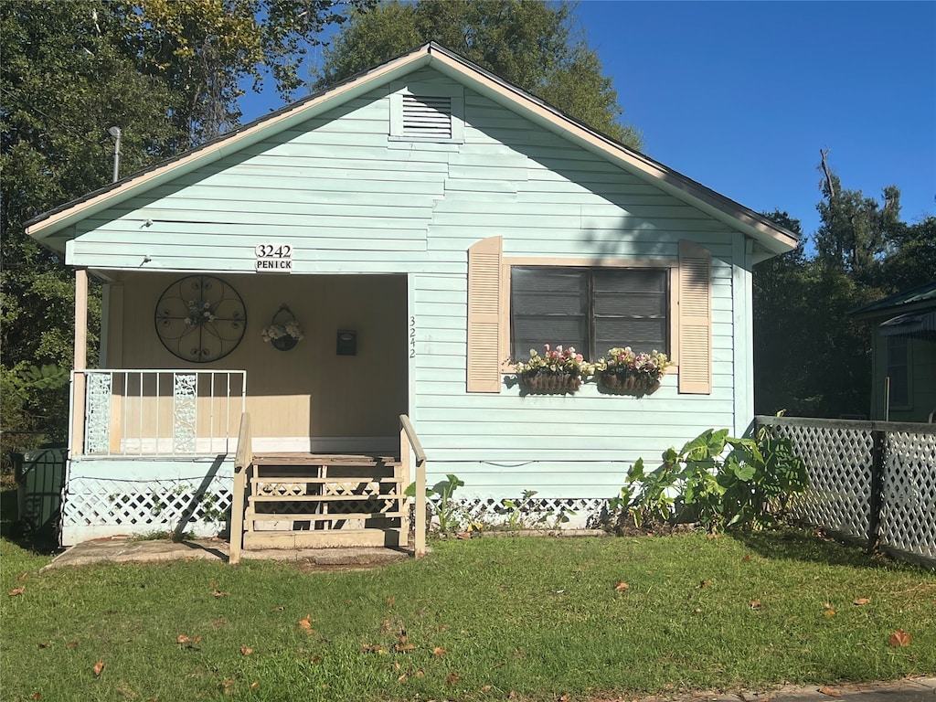 bungalow-style house with a porch and a front yard