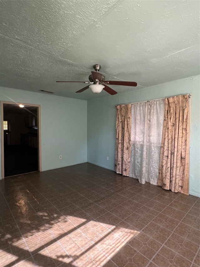 spare room featuring ceiling fan and a textured ceiling