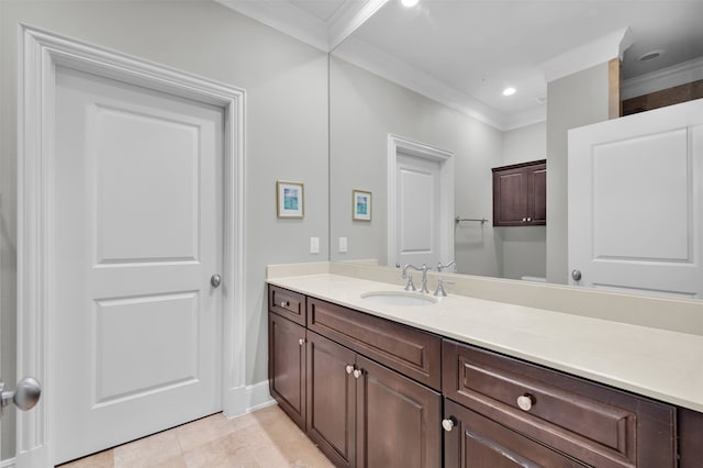 bathroom featuring tile patterned floors, crown molding, and vanity