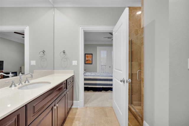 bathroom featuring vanity, tile patterned floors, a shower with door, and ornamental molding