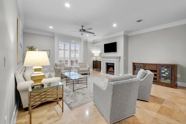 living room with ceiling fan and crown molding