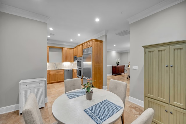 tiled dining space featuring ornamental molding and sink