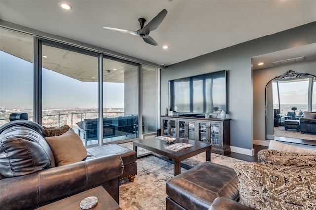 living room featuring ceiling fan and wood-type flooring