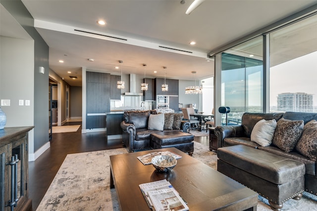 living room featuring floor to ceiling windows, dark hardwood / wood-style floors, and a notable chandelier