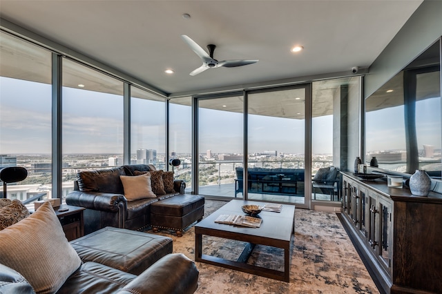 living room with ceiling fan, expansive windows, and a healthy amount of sunlight