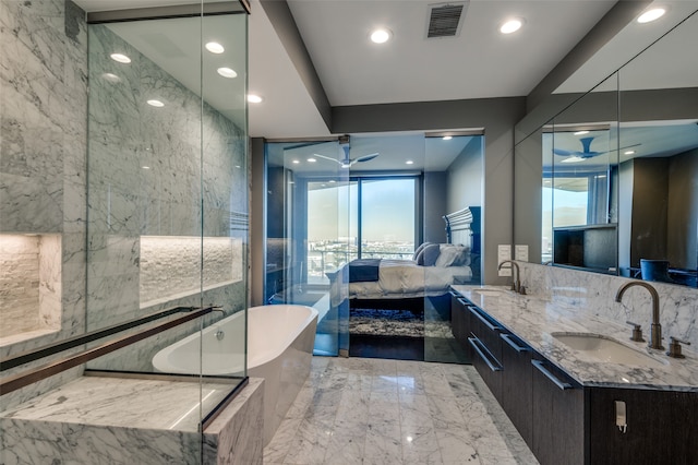 bathroom featuring ceiling fan, vanity, a wealth of natural light, and tiled bath