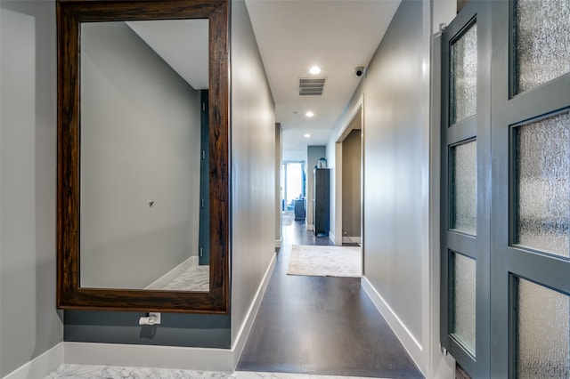 hallway with hardwood / wood-style floors