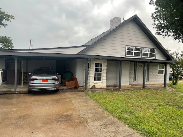 view of front facade with a carport and a front lawn