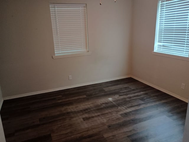 unfurnished room featuring dark hardwood / wood-style flooring