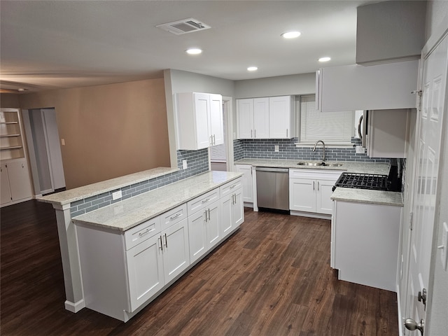 kitchen featuring white cabinetry, dishwasher, sink, dark hardwood / wood-style floors, and kitchen peninsula