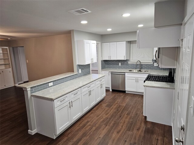714 Austrian Rd, Grand Prairie, TX 75050 - kitchen featuring dishwasher, a sink, dark wood-style floors, white cabinetry, and tasteful backsplash