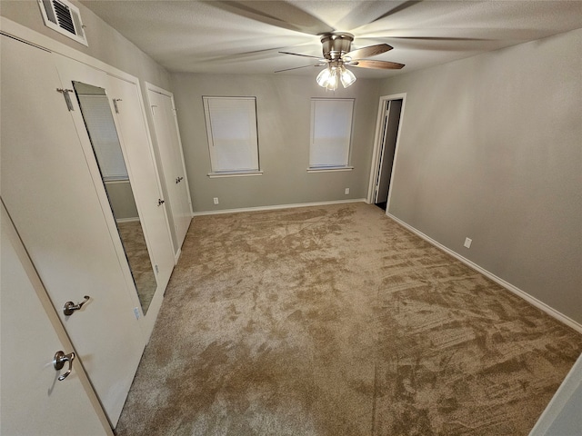 unfurnished bedroom with ceiling fan and light colored carpet