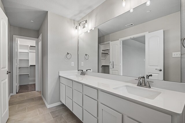 bathroom with tile patterned floors and vanity