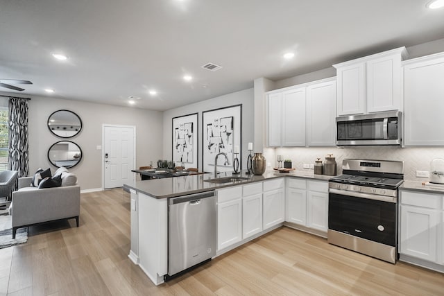 kitchen featuring white cabinetry, sink, and appliances with stainless steel finishes