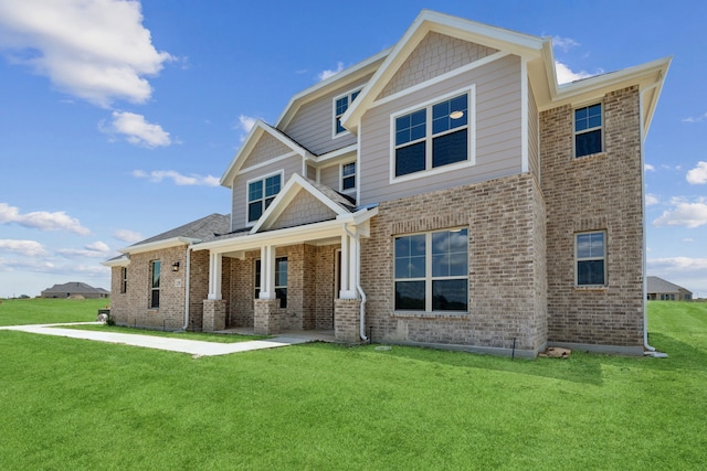 craftsman-style home featuring a front lawn and covered porch