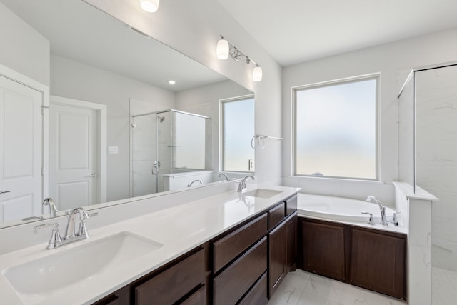 bathroom with vanity and independent shower and bath