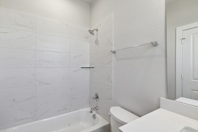 bathroom with tiled shower / bath combo and toilet