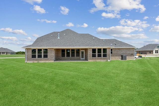 rear view of property featuring a yard