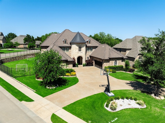 french country style house featuring a garage and a front yard