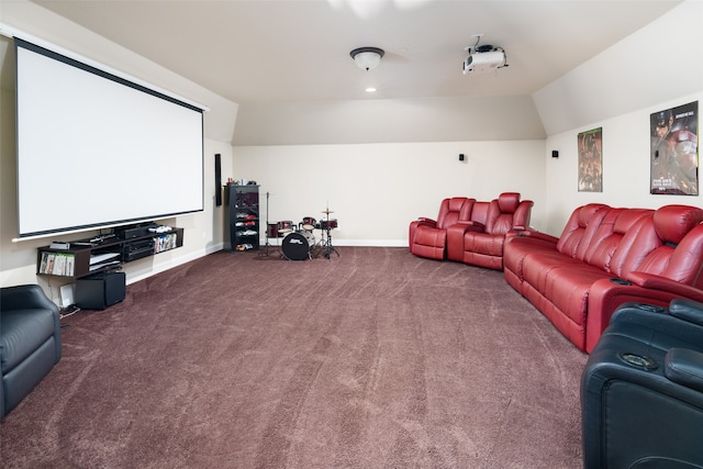 cinema featuring vaulted ceiling and carpet flooring