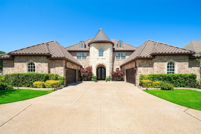 view of front of home with a garage and a front yard