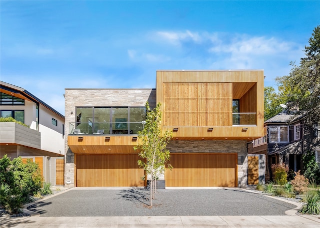 modern home featuring a balcony and a garage