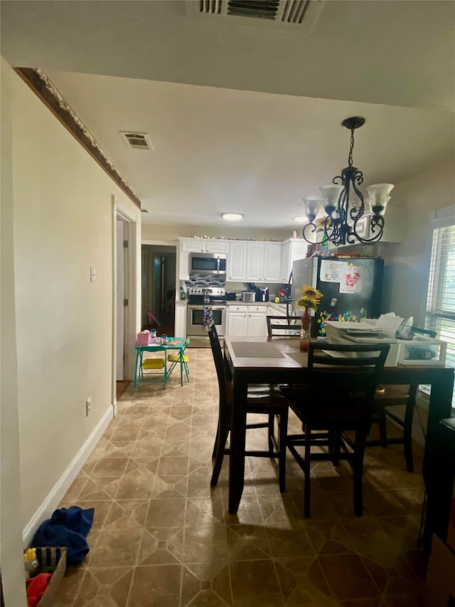 tiled dining room with a notable chandelier