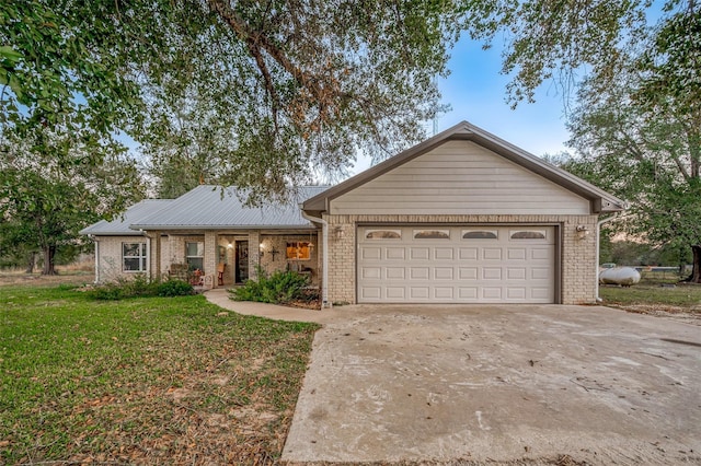 single story home with a garage and a front lawn