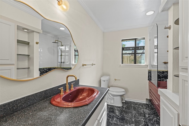 bathroom featuring vanity, ornamental molding, toilet, and tiled shower