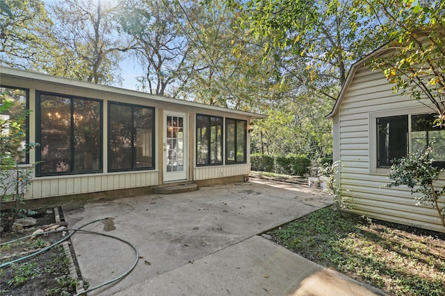 view of patio / terrace featuring a sunroom