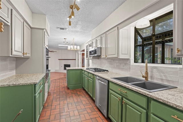 kitchen featuring sink, white cabinetry, green cabinets, pendant lighting, and stainless steel appliances