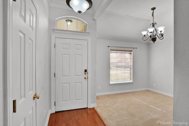 entryway with hardwood / wood-style floors and an inviting chandelier