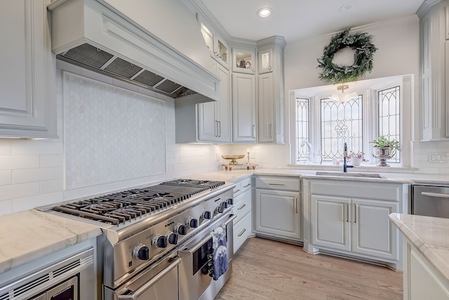 kitchen featuring white cabinetry, premium range hood, and stainless steel appliances