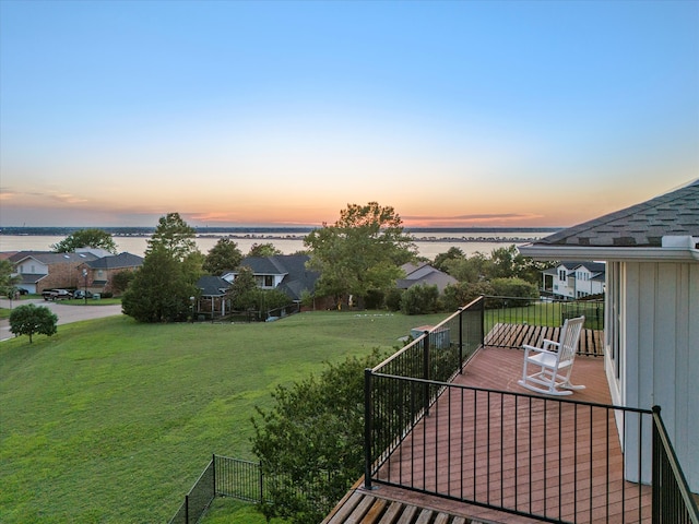 exterior space with a water view and a lawn