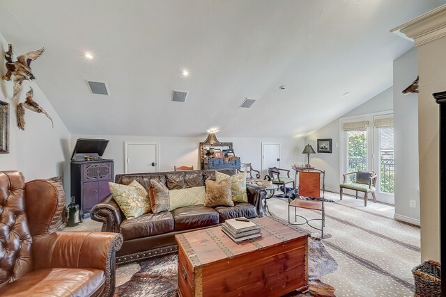 living room featuring carpet floors and vaulted ceiling